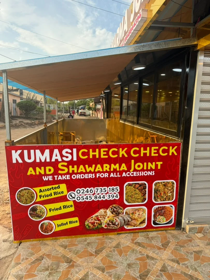 Original photo of the Kumasi CheckCheck outdoor dining area and sign